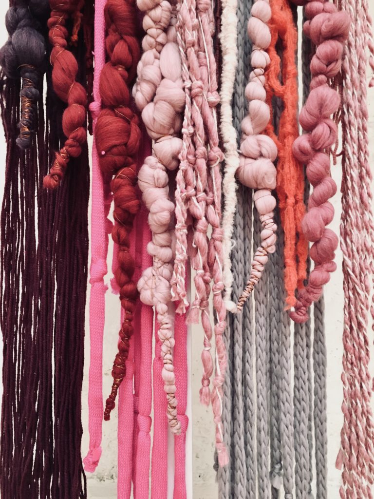 Almarios by Kristie Arias - based on inca-knot records turned into modern art installations. Thread knotted in pink, mauve, purple and grey.
